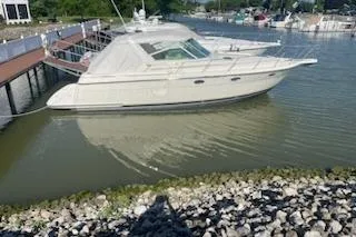 Slide: The Image of 1995 Tiara Express boat docked in a calm marina setting. - 1