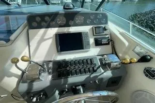 Slide: The Image of 1995 Tiara Express boat dashboard with navigation controls and gauges. - 4
