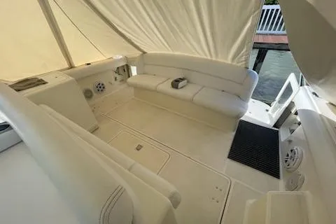 Slide: The Image of 1995 Tiara Express yacht interior with white seating and covered deck area. - 5