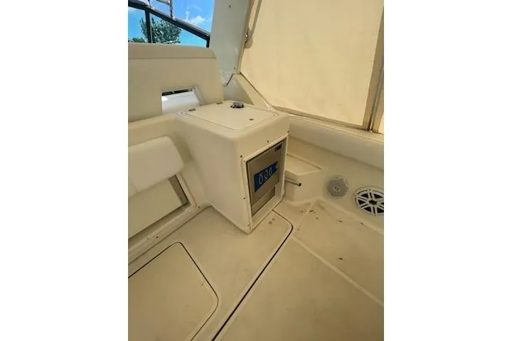 Slide: The Image of Interior of a 1995 Tiara Express boat, featuring seating and storage compartments. - 6