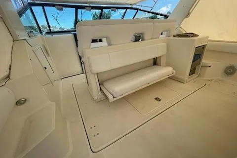 Slide: The Image of 1995 Tiara Express boat interior with white seating and helm area. - 7