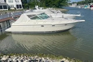 Slide: The Image of 1995 Tiara Express boat docked in a serene marina setting. - 9