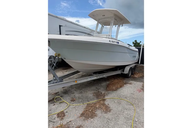 The Image of 2017 Robalo R222 Center Console boat on trailer, parked outdoors. - 12