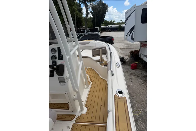 Slide: The Image of 2017 Robalo R222 Center Console boat with teak flooring and control panel. - 14