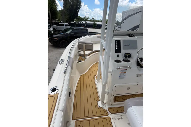 Slide: The Image of 2017 Robalo R222 Center Console boat interior with Garmin navigation system and teak flooring. - 15