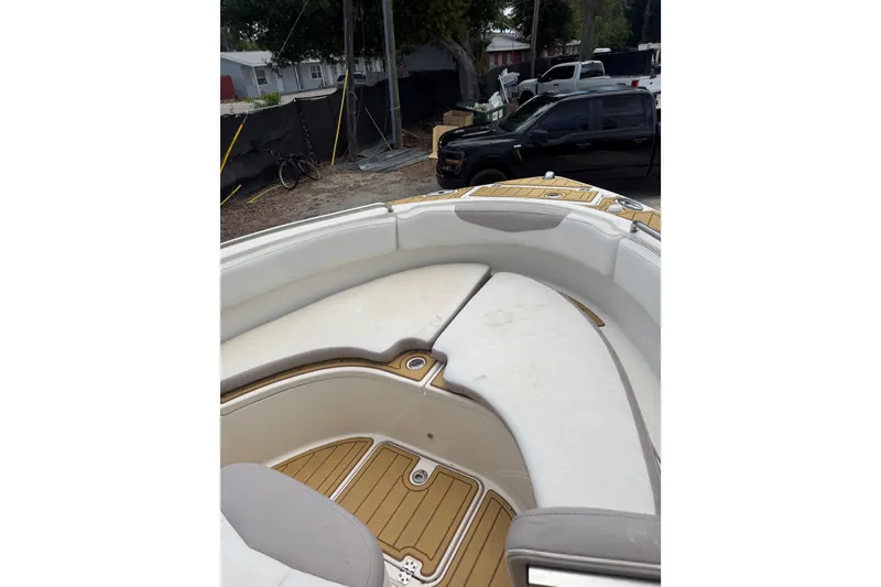 Slide: The Image of 2017 Robalo R222 Center Console boat interior with cushioned seating and teak flooring. - 17