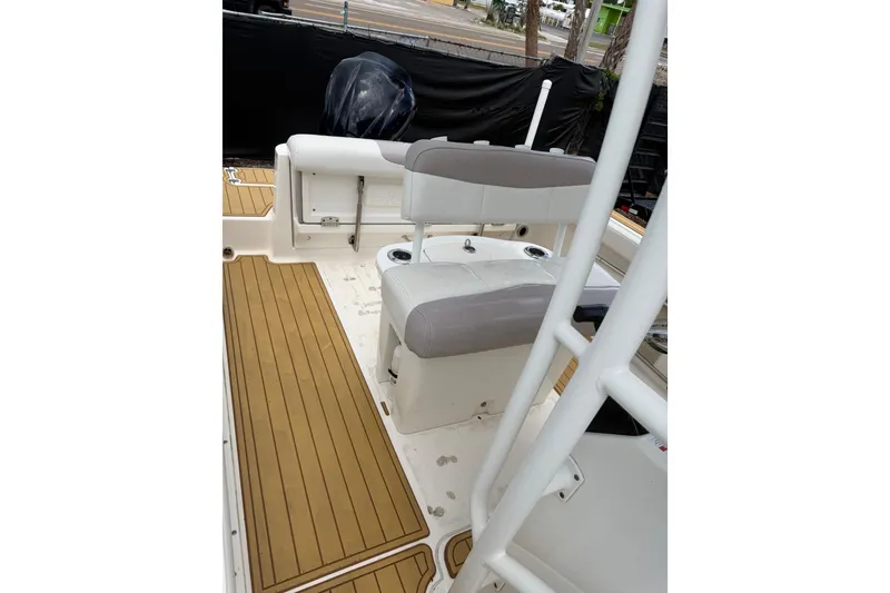 Slide: The Image of 2017 Robalo R222 Center Console boat interior with seating and teak-style flooring. - 19
