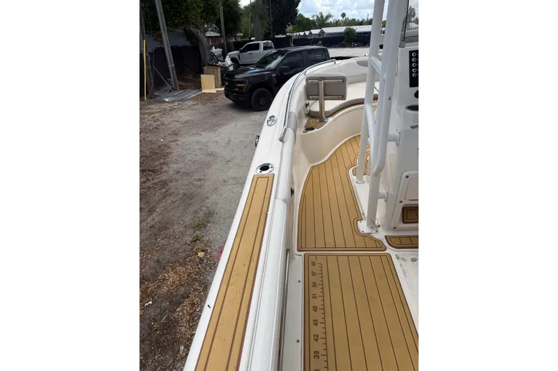 Slide: The Image of 2017 Robalo R222 Center Console boat with tan deck, parked outdoors. - 22