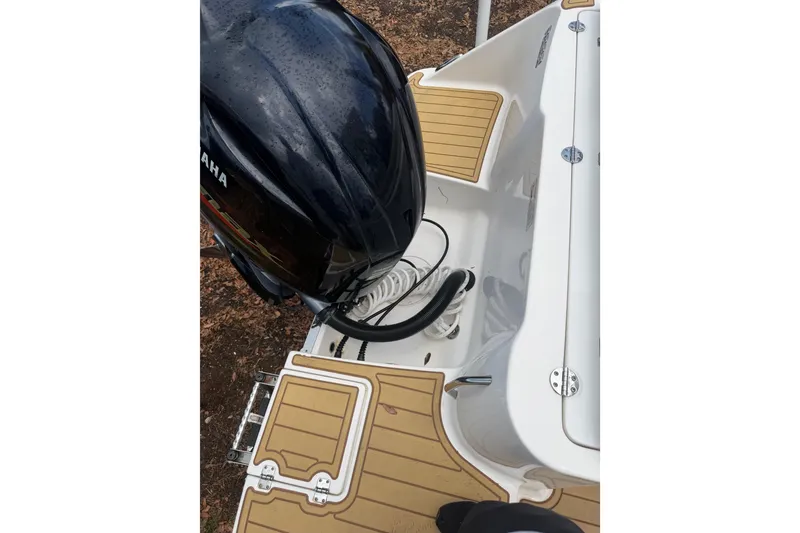 Slide: The Image of 2017 Robalo R222 Center Console boat with Yamaha outboard motor and teak-style deck. - 23