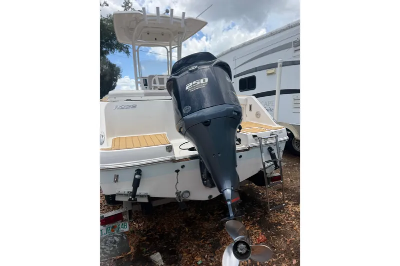 Slide: The Image of 2017 Robalo R222 Center Console boat with 250 horsepower outboard motor, parked outdoors. - 24