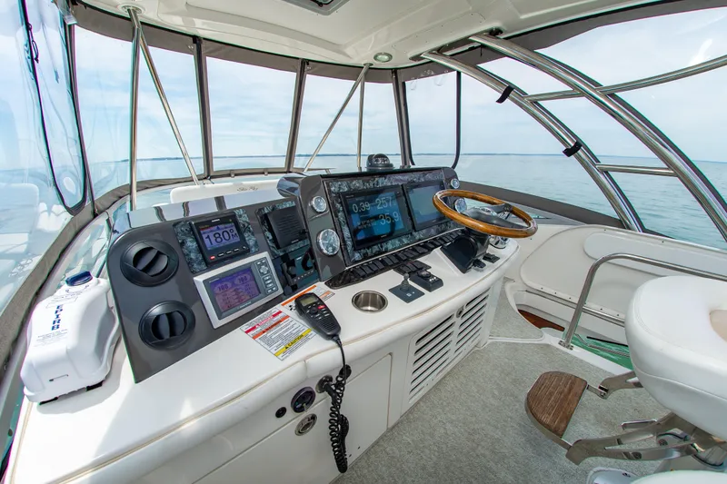 Slide: The Image of Helm of 2008 Sea Ray 47 Sedan Bridge yacht with advanced navigation controls and panoramic view. - 1