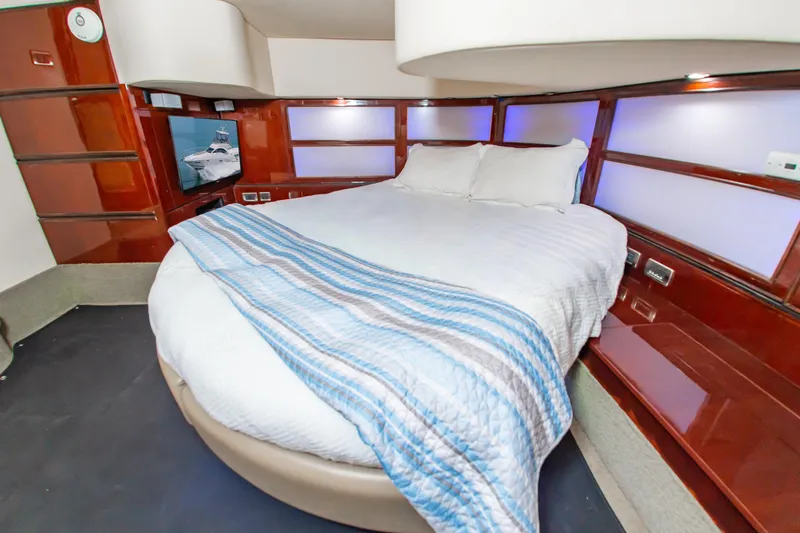 Slide: The Image of Luxurious bedroom interior of 2008 Sea Ray 47 Sedan Bridge yacht with cozy bedding. - 11