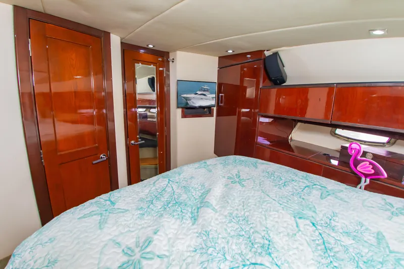 Slide: The Image of Luxurious 2008 Sea Ray 47 Sedan Bridge cabin with elegant wood finishes and cozy bedding. - 14