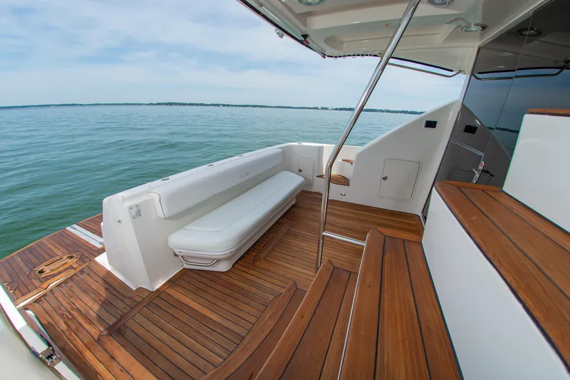 Slide: The Image of 2008 Sea Ray 47 Sedan Bridge yacht with teak deck and seating, overlooking serene waters. - 24