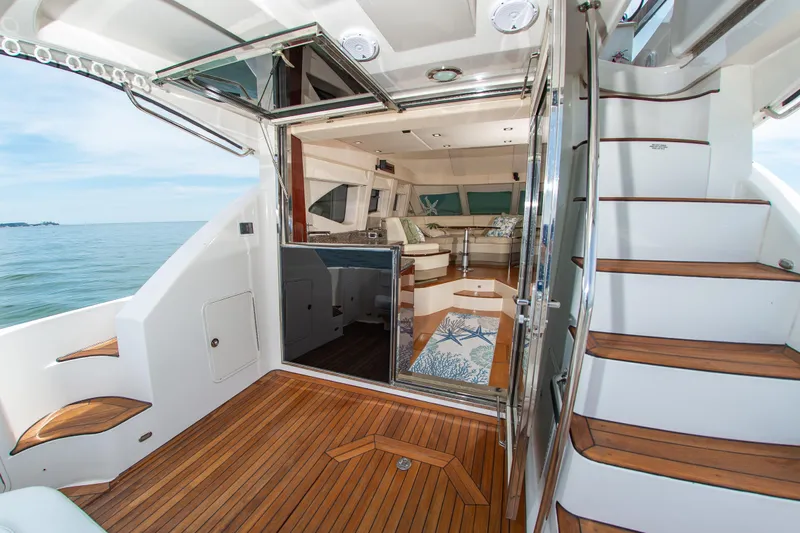 Slide: The Image of Luxurious 2008 Sea Ray 47 Sedan Bridge yacht interior with wooden deck and elegant seating. - 29
