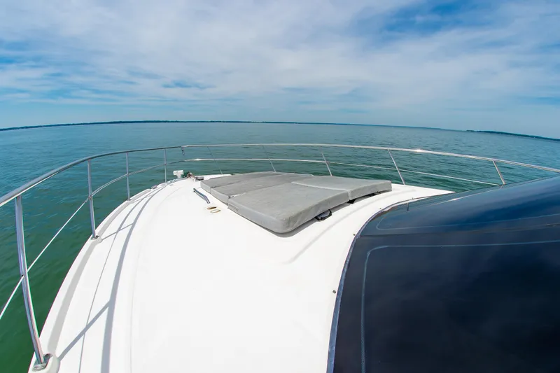 Slide: The Image of 2008 Sea Ray 47 Sedan Bridge yacht deck with ocean view under clear sky. - 37