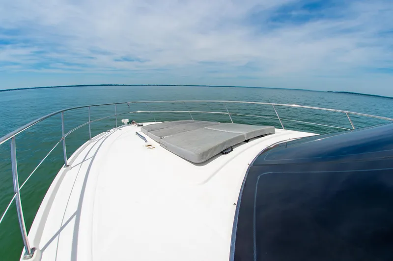 Slide: The Image of 2008 Sea Ray 47 Sedan Bridge yacht deck with ocean view under blue sky. - 40