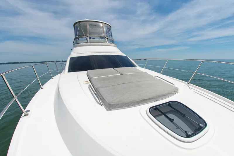 Slide: The Image of 2008 Sea Ray 47 Sedan Bridge yacht on calm water under blue sky. - 41