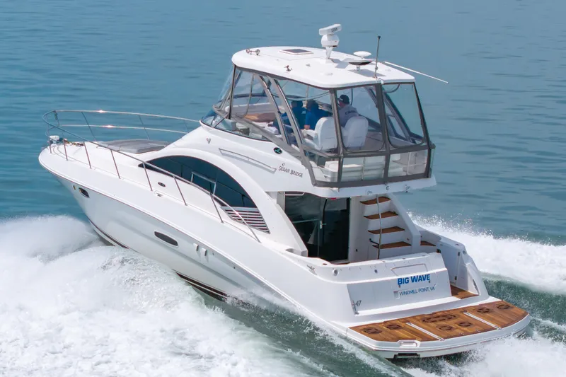 Slide: The Image of 2008 Sea Ray 47 Sedan Bridge yacht cruising on open water. - 42
