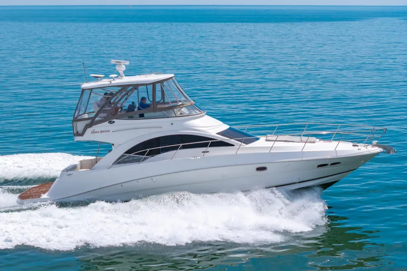 Slide: The Image of 2008 Sea Ray 47 Sedan Bridge yacht cruising on open water. - 46