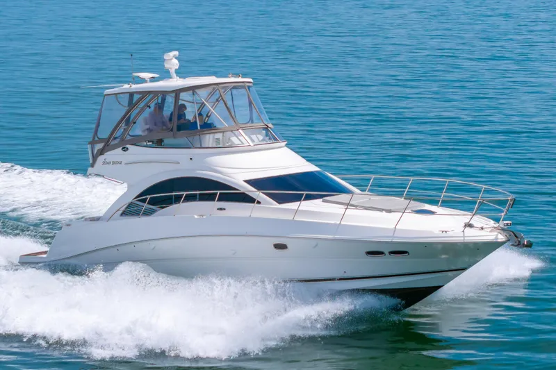 Slide: The Image of 2008 Sea Ray 47 Sedan Bridge yacht cruising on open water. - 47
