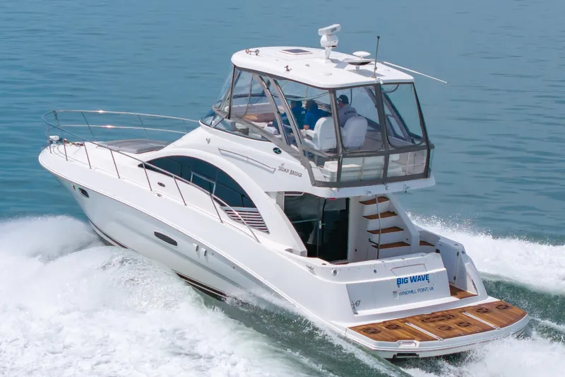 Slide: The Image of 2008 Sea Ray 47 Sedan Bridge yacht cruising on open water. - 49