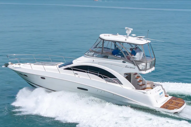 Slide: The Image of 2008 Sea Ray 47 Sedan Bridge yacht cruising on open water. - 50