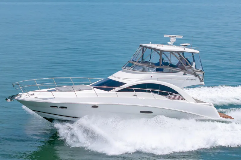 Slide: The Image of 2008 Sea Ray 47 Sedan Bridge yacht cruising on calm blue waters. - 51