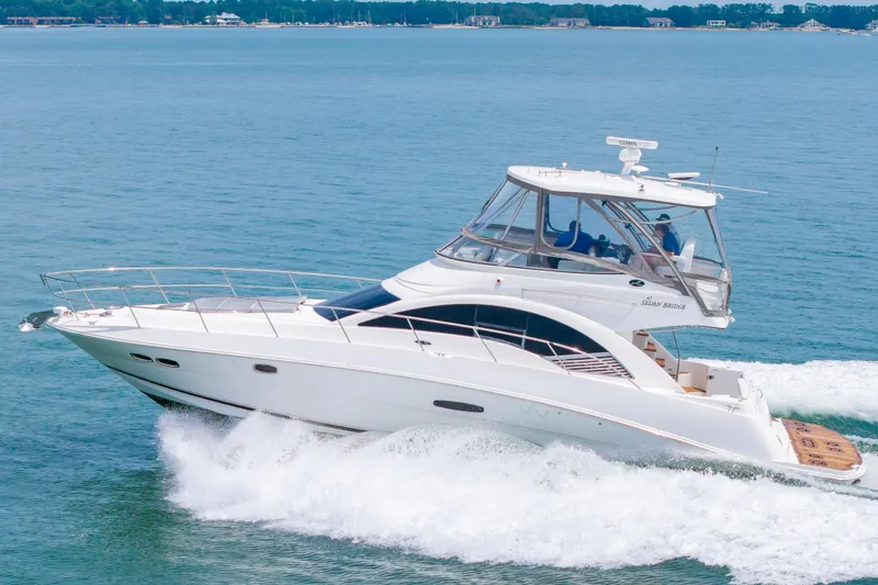 Slide: The Image of 2008 Sea Ray 47 Sedan Bridge yacht cruising on open water. - 54