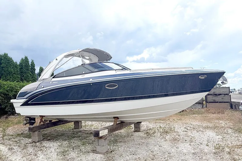 Slide: The Image of 2022 Formula 290 Bowrider boat on dry land, showcasing sleek design and modern features. - 0