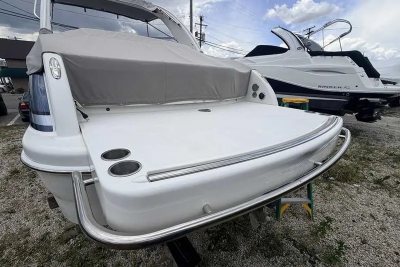 Slide: The Image of 2022 Formula 290 Bowrider boat with covered seating, docked outdoors. - 1