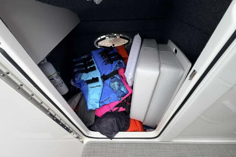 Slide: The Image of Storage compartment in 2022 Formula 290 Bowrider with life jackets and cushions. - 15