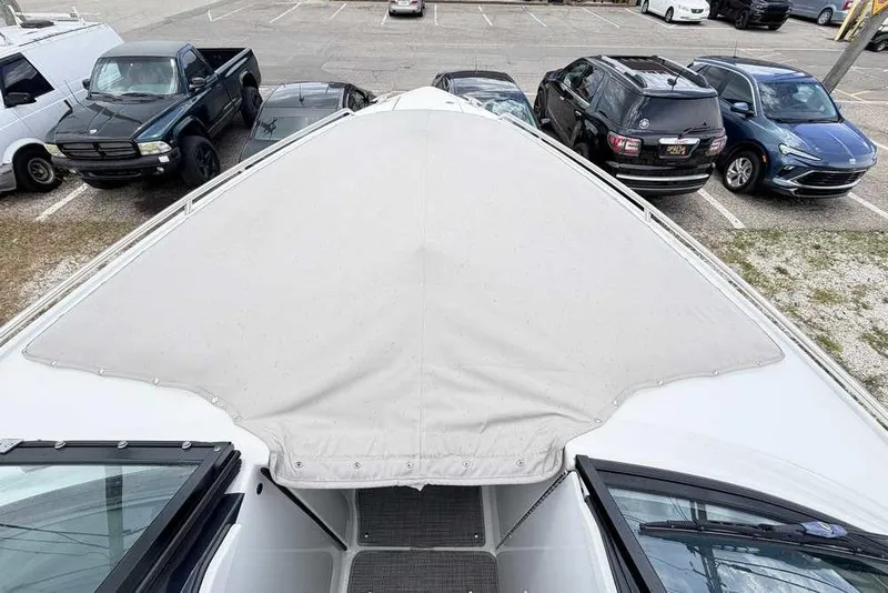 Slide: The Image of 2022 Formula 290 Bowrider boat with covered bow in parking lot. - 16
