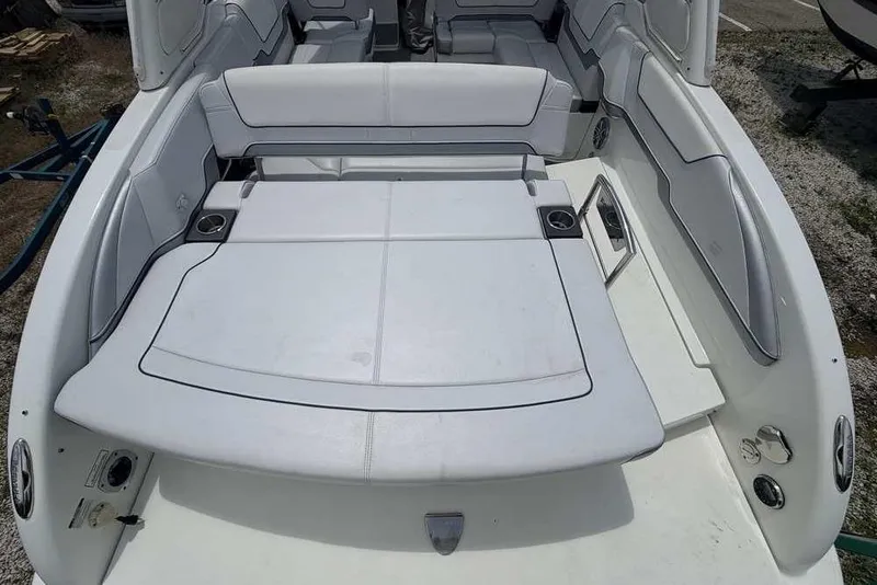 Slide: The Image of 2022 Formula 290 Bowrider boat interior with white seating and cup holders. - 2