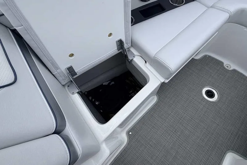 Slide: The Image of 2022 Formula 290 Bowrider interior storage compartment with gray seating and flooring. - 20