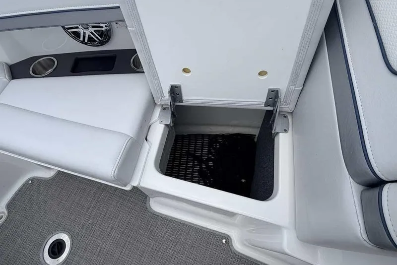 Slide: The Image of 2022 Formula 290 Bowrider interior storage compartment with white seating and cup holders. - 21