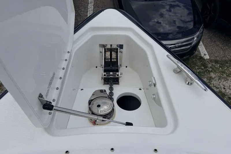 Slide: The Image of Open anchor compartment on 2022 Formula 290 Bowrider boat, showcasing anchor chain and winch. - 23