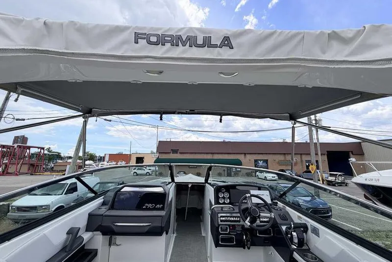 Slide: The Image of 2022 Formula 290 Bowrider boat interior with canopy and modern dashboard controls. - 3