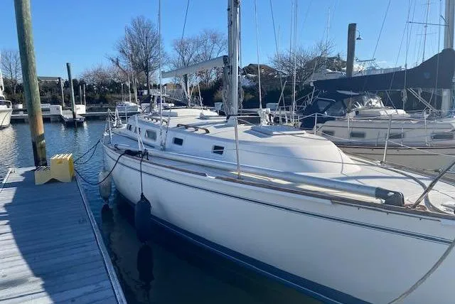 The Image of 1991 Freedom Yachts 38 sailboat docked at a marina on a sunny day. - 0