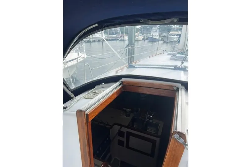 Slide: The Image of Cockpit view of a 1991 Freedom Yachts 38 sailboat docked at a marina. - 10