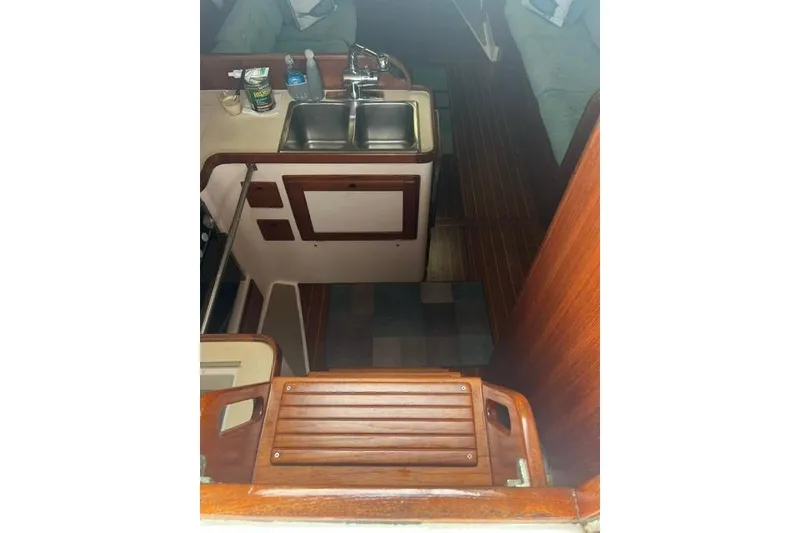Slide: The Image of Interior view of 1991 Freedom Yachts 38, featuring a compact kitchen area. - 13