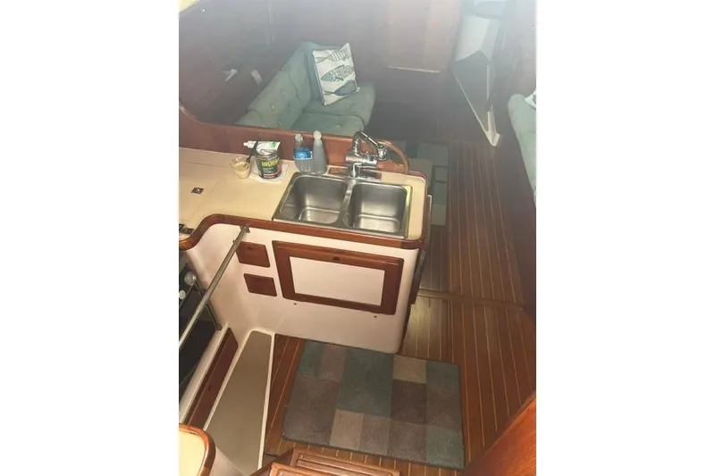Slide: The Image of Interior of 1991 Freedom Yachts 38, featuring a compact kitchen with double sink. - 14