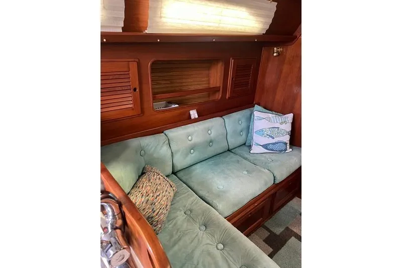 Slide: The Image of Cozy interior of 1991 Freedom Yachts 38 with cushioned seating and decorative pillows. - 16