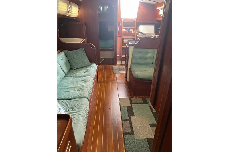 Slide: The Image of Interior of 1991 Freedom Yachts 38, featuring cozy seating and wooden flooring. - 17