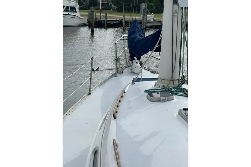Slide: The Image of Sailboat deck view of 1991 Freedom Yachts 38, docked in a serene marina. - 2