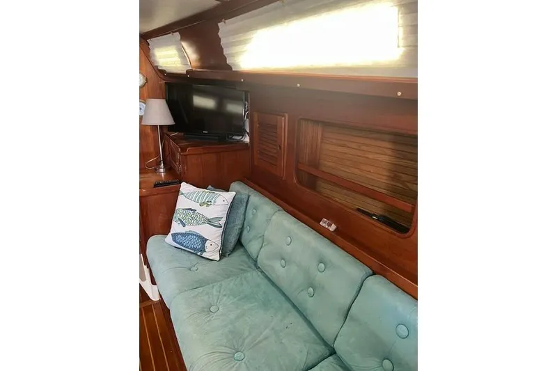 Slide: The Image of Interior of 1991 Freedom Yachts 38 with teal sofa and nautical decor. - 20