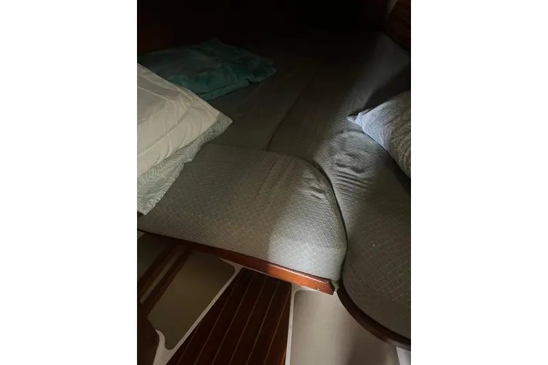 Slide: The Image of Cozy cabin bed inside a 1991 Freedom Yachts 38 sailboat, featuring soft pillows and cushions. - 29