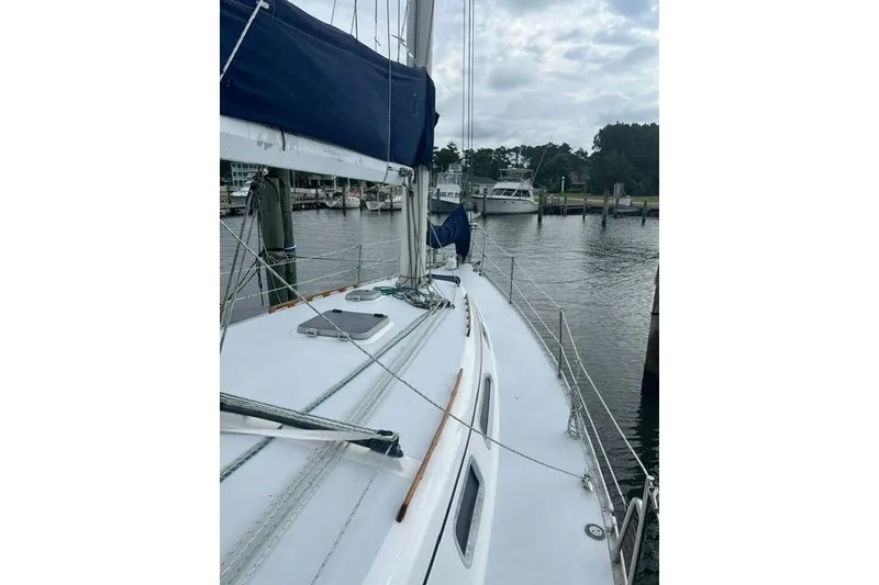 Slide: The Image of 1991 Freedom Yachts 38 sailboat docked at a marina, featuring a sleek deck design. - 5