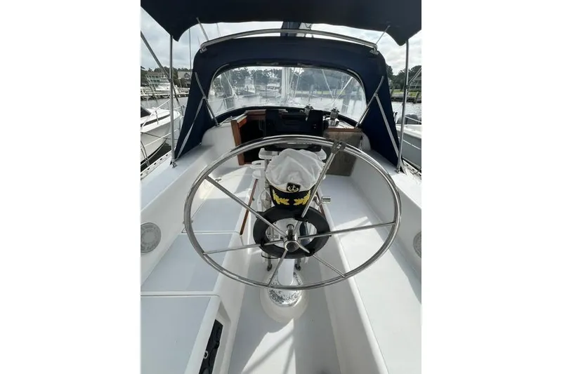 Slide: The Image of 1991 Freedom Yachts 38 sailboat cockpit with steering wheel and canopy. - 9