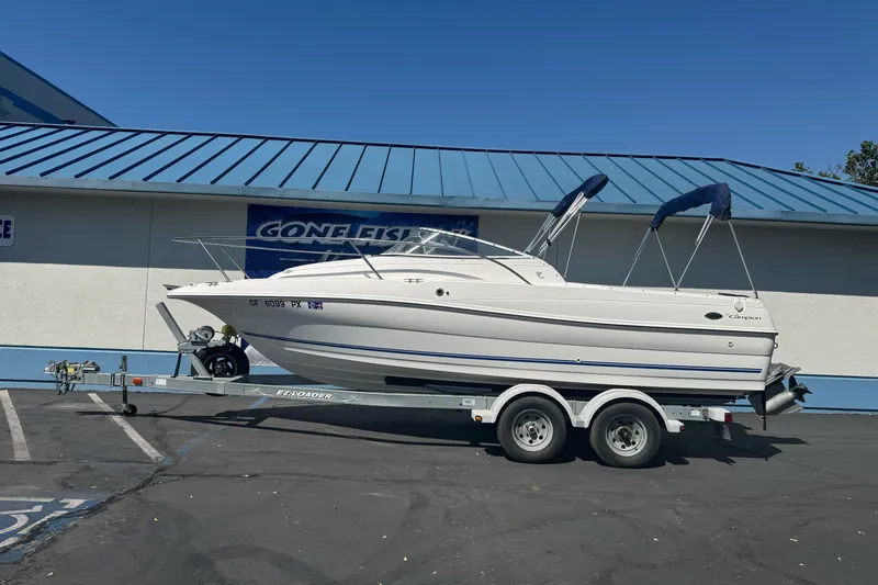 The Image of 2002 Campion Explorer 602 Sport Cabin boat on trailer, parked outside a building. - 1